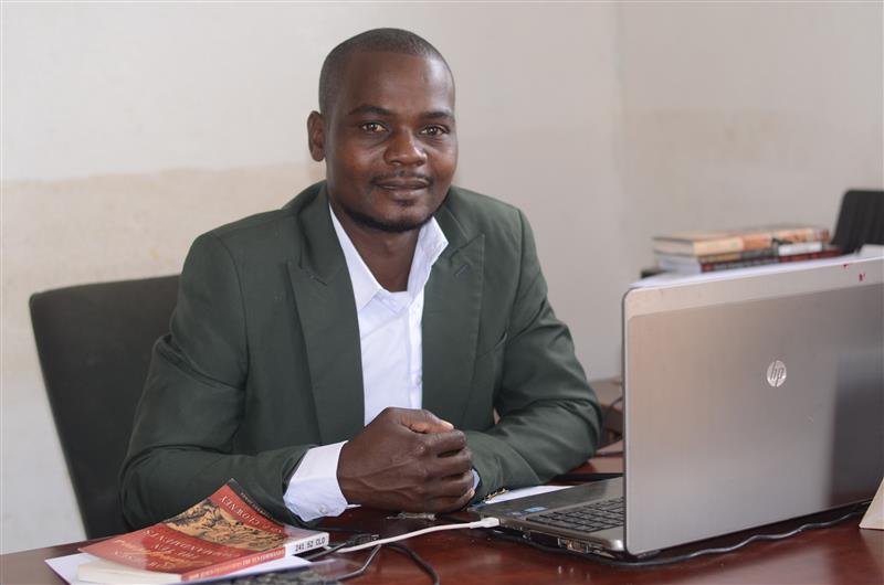 Geoffrey Matthews Mandota smiling confidently, dressed in formal attire, representing his role as an evangelist and community author.