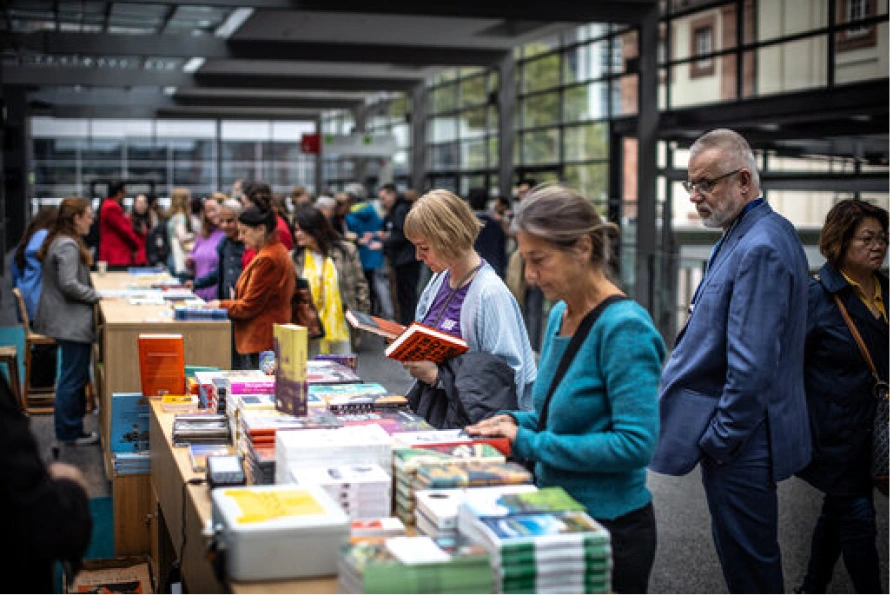 Visitors browsing books at the Frankfurt Book Fair 2025 inside Messe Frankfurt.